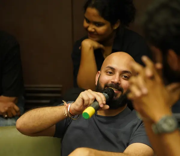 Manas holding a mic